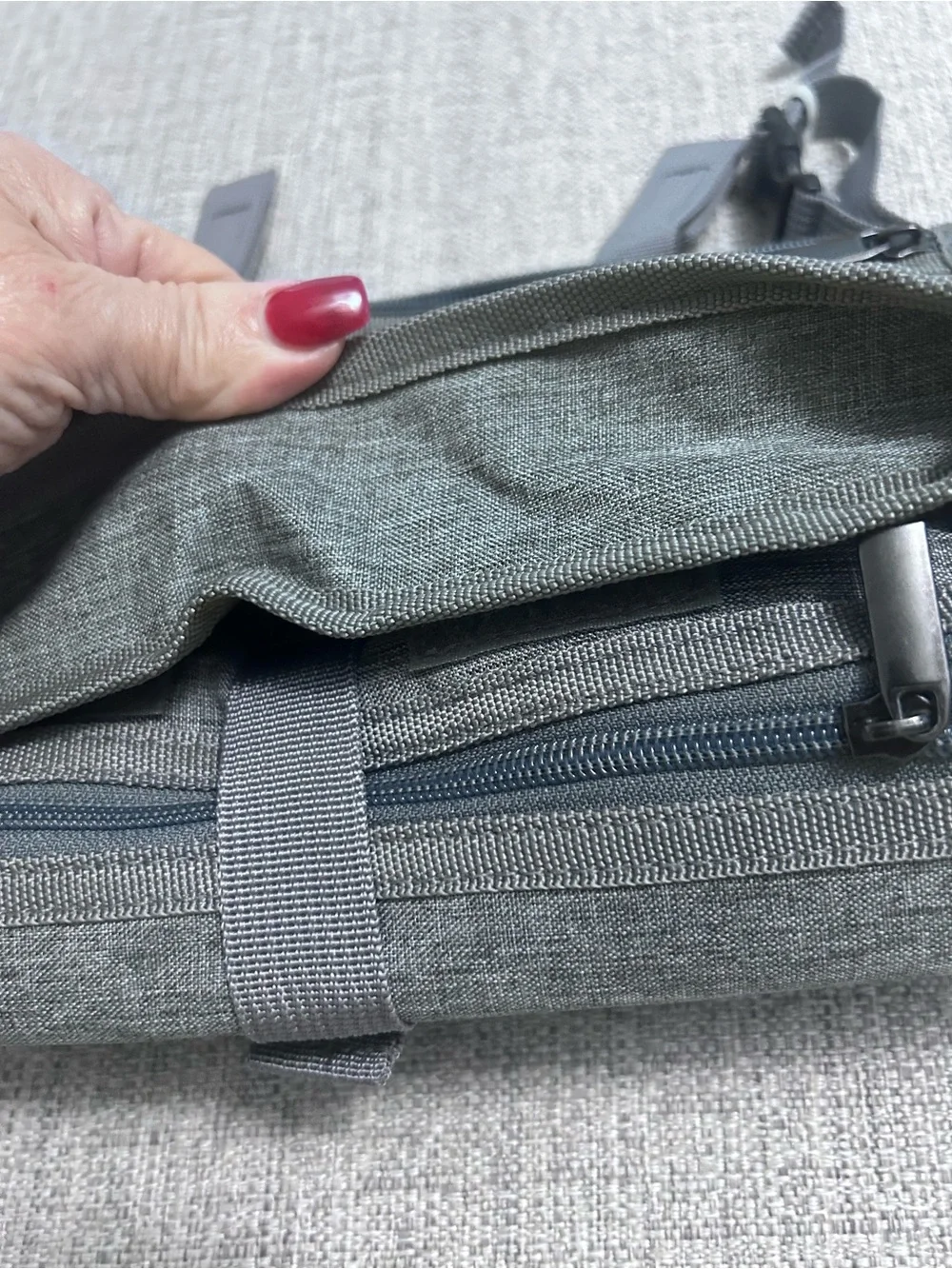 Grey Foldable Portable Changing Pad for Baby with Secure Buckle.